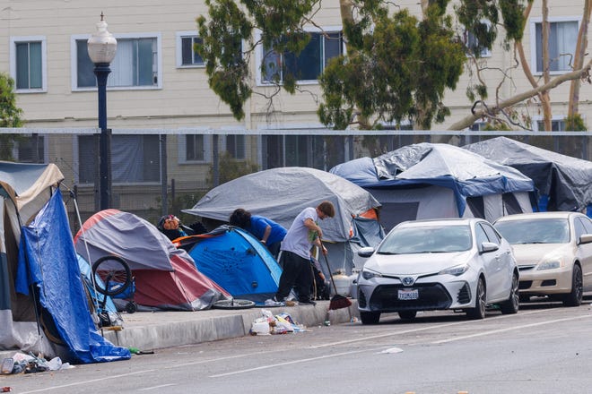 A sidewalk filled with tents is shown on July, 31,2023 as enforcement begins of San Diego's Unsafe Camping Ordinance that prohibits tent encampments in all public spaces throughout the city if shelter beds are available.