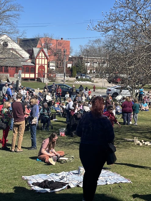 The Dover Public Library lawn is crowded for its solar eclipse viewing party Monday, April 8, 2024.