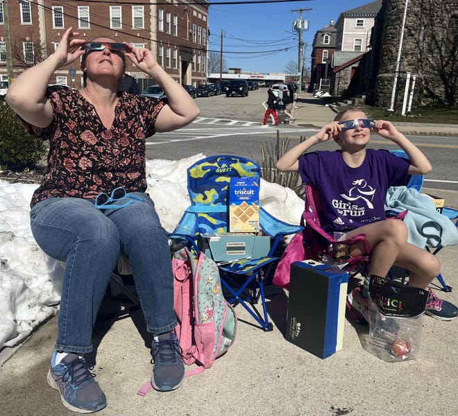 Stephanie Dornsife and daughter Caroline Dornsife observing the solar eclipse at the Dover Public Library Monday, April 8, 2024.