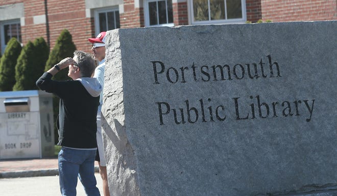A crowd gathered to view the eclipse outside Portsmouth Public Library Monday, April 8, 2024.