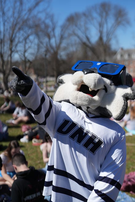 Wild E. Cat enjoys an eclipse viewing event at the University of New Hampshire on the Thompson Hall lawn Monday, April 8, 2024.